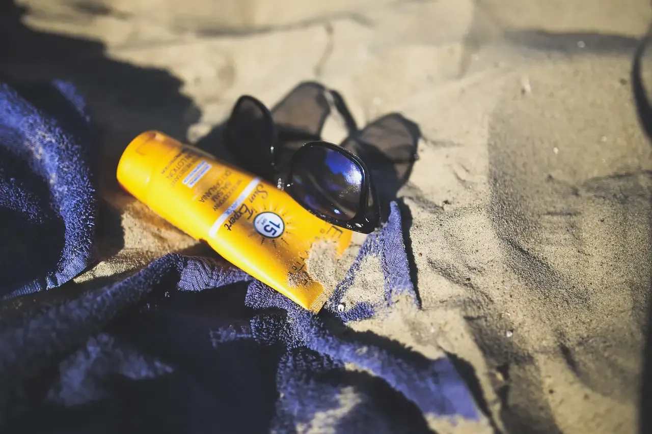 Sunblock Sunglass on beach sand